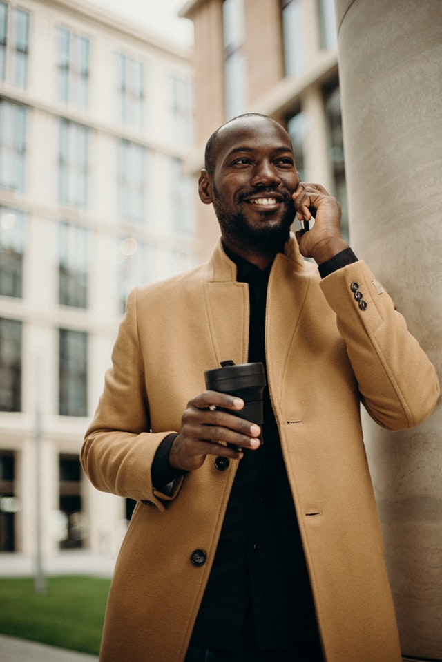 man-wearing-brown-jacket-using-smartphone-while-using-3206114.jpg